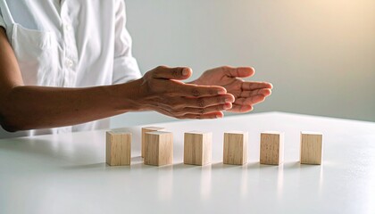 Demonstrating balance techniques with wooden blocks indoor workspace educational content minimalistic environment close-up view