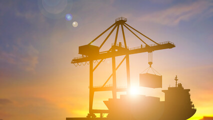 Silhouette port crane lifting container from cargo ship