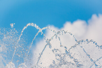 Splashes and jets of water against light background.