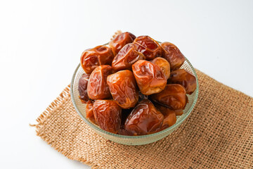 Dates fruit sukari or kurma sukari, in bowl isolated on white background