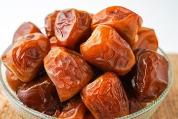 Dates fruit sukari or kurma sukari, in bowl isolated on white background