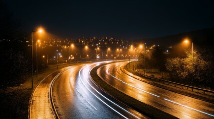 Night highway curves illuminated by streetlights.