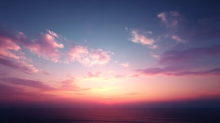 A breathtaking panorama displays vibrant sunset colors reflecting on tranquil ocean waves as the day transitions into night at a coastal setting