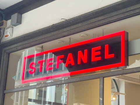 Stefanel storefront sign with neon red design on urban street