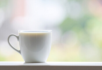 Fototapeta premium A glass of milk against a soft blur background. 