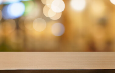Empty wood table top and blur of restaurant background selective focus product display