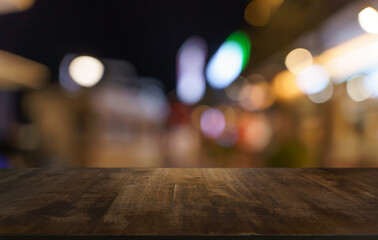 Empty wood table top and blur of restaurant background selective focus product display