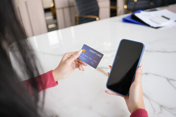 Woman shopping on laptop holding credit card for Internet online e-commerce shopping spending money Online shopping Mobile phone laptop technology concept
