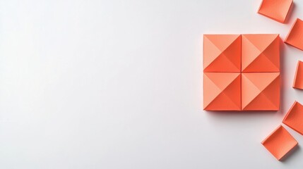 A square of orange paper with four triangles on each side.