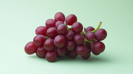 Fototapeta premium A vibrant bunch of grapes rests on a light green background.