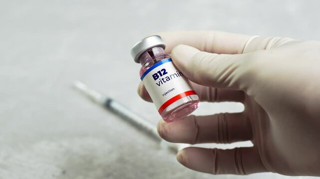 a doctor checks the vitamin b 12 in a vial and shows it to the camera. health and medical concepts.