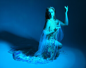 Fantasy studio portrait of a red-haired mermaid faery model wearing white pearl gown, fairytale...