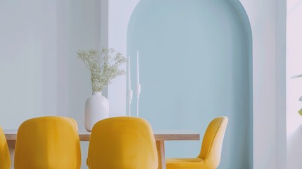 Modern dining room with yellow chairs and soft color scheme