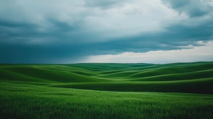 Obraz premium Serene Rolling Green Hills Under Dramatic Sky Nature Landscape Photography view calm field grass
