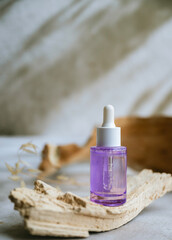 Bakuchiol face serum in a glass bottle on shadows background 