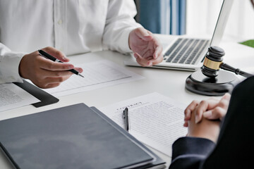 Lawyer with lawsuit meeting with client discussing with contract agreement at law firm