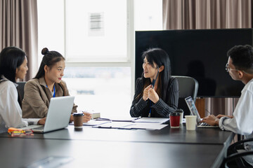 Business team discuss and collaborating on project during meeting