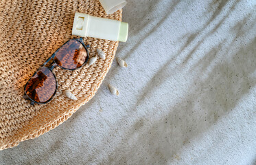 Sunscreen stick , Straw hat and sunglasses on shadows background