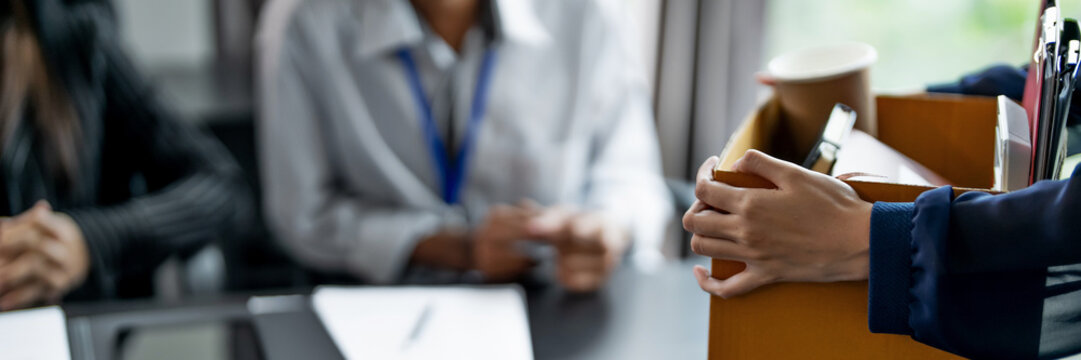 Resignation concept.Businesswoman packing Stuff with cardboard box for quit a job