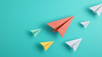 Paper airplanes leadership concept unique colored plane on teal background 