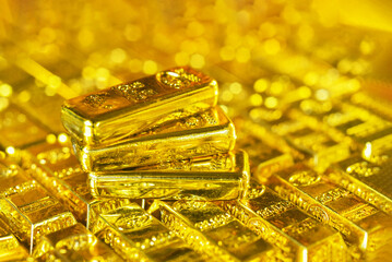Stacking gold bars with golden light. Gold is hard commodity goods, risk asset, tangible value that used to be gold reserve, save assets during war and economic crisis