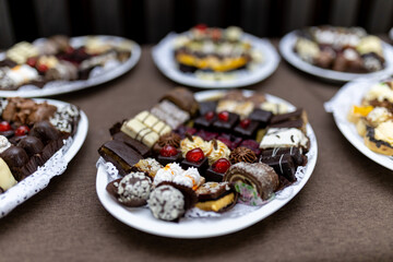 Desserts arranged on platters at a festive gathering showcasing a variety of sweet treats