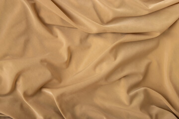 Obraz premium Elegant fabric texture in warm beige color with soft flowing folds and creases
