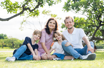 Fototapeta premium Happy family parent children having picnic outdoor activity. Enjoy happiness moment summer playing together including father mother son and daughter relaxing in the morning sunrise.
