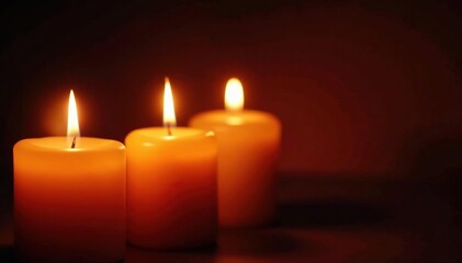Close-up of several lit church candles, glowing warmly against a dark background , devotion, ambiance