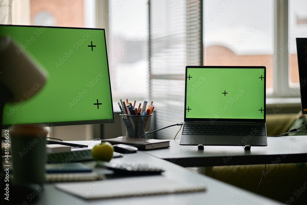 Poster multiple screens with tracking markers visible in modern office setting featuring gadgets and electr