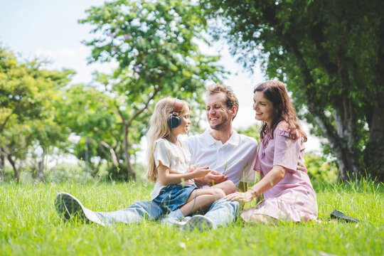 Happy family parent children having picnic outdoor activity. Enjoy happiness moment summer playing together including father mother son and daughter relaxing in the morning sunrise.