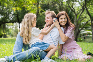 Fototapeta premium Happy family parent children having picnic outdoor activity. Enjoy happiness moment summer playing together including father mother son and daughter relaxing in the morning sunrise.