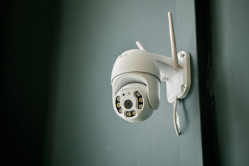 Functional security surveillance camera mounted on wall. Equipped with multiple sensors and wireless antennas for enhanced monitoring capability