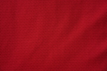 Close up of red football jersey sports clothing fabric texture.