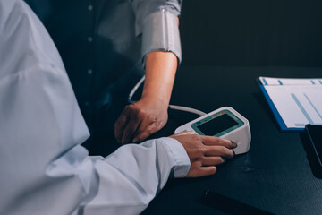 Close-up of doctor checking blood pressure