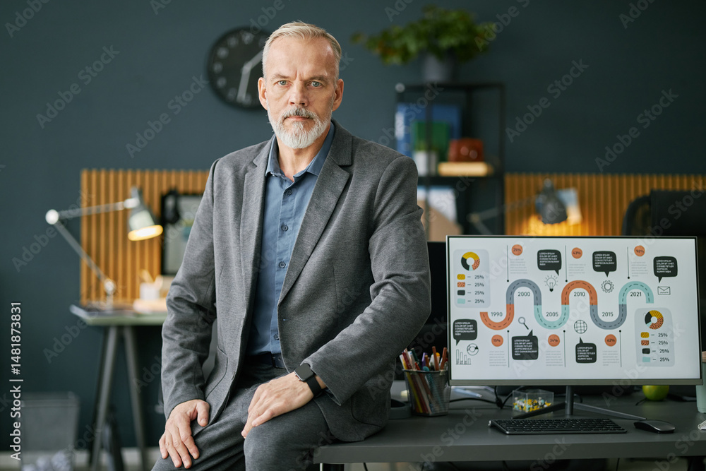 Aufkleber portrait of senior business professional analyzing data on illuminated screen in modern office equip