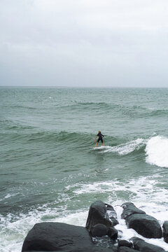 Boy surfs the ocean waves in Australia