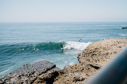 Surfers riding waves off California coast