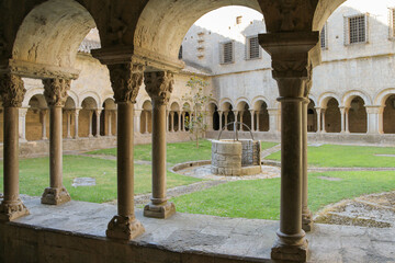 The courtyard of an ancient monastery with a well in the middle