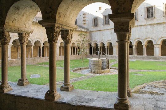 The courtyard of an ancient monastery with a well in the middle