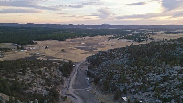 Expansive aerial view of vast rocky terrain with forested hills in Valle de los Monjes, Chihuahua