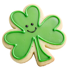 A green cookie with a smiling face on it. The cookie is shaped like a clover and has a green frosting