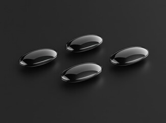 Four black glossy oval pills on a dark surface