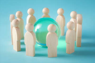Circle of wooden figures encircling a crystal ball concept of community connection