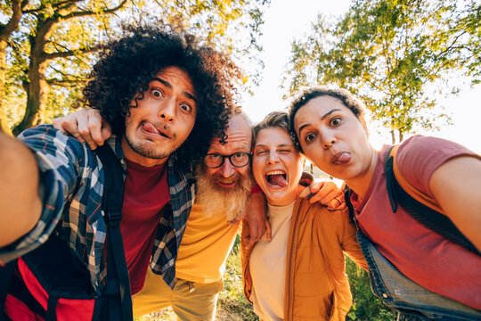 Hikers making funny faces and taking a selfie in the woods