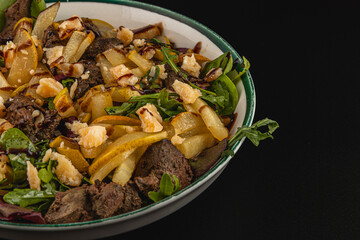 Culinary delight with mixed greens and savory meat dish