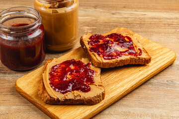 Delicious peanut butter and jelly sandwiches on wooden board