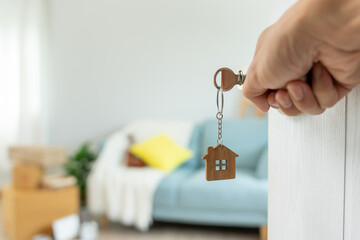 Moving house, relocation. Man open door in new apartment. move in new home. Buy or rent real...