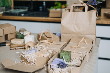 A collection of natural handmade soap bars, cardboard packaging, and eco-friendly gift wrapping...
