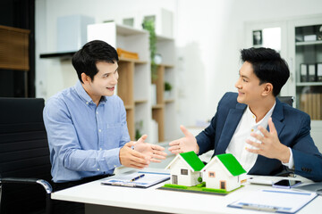 Professional team collaboration in modern office, discussing real estate model and signing contract, concept of startup